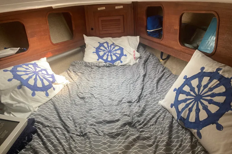 Slide: The Image of Cozy cabin interior of a 1979 CAL 34-III sailboat with nautical-themed bedding. - 27