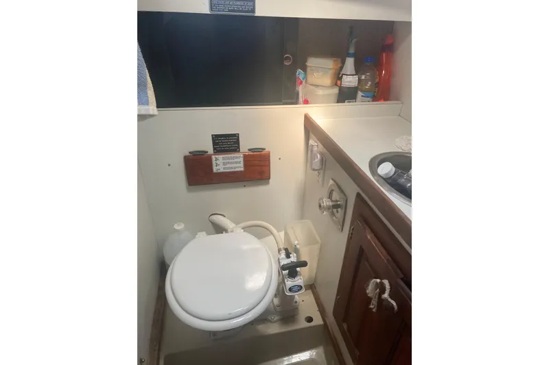 Slide: The Image of Compact marine bathroom in a 1979 CAL 34-III sailboat, featuring a toilet and sink. - 29