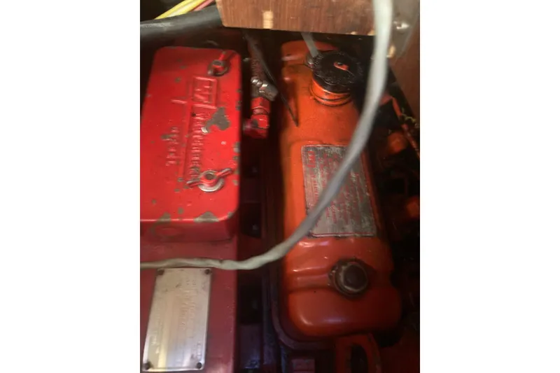 Slide: The Image of Red engine components of a 1979 CAL 34-III sailboat, featuring visible wiring and labels. - 30