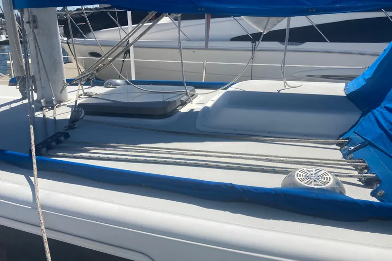 Slide: The Image of 1979 CAL 34-III sailboat deck with blue covers and rigging in marina. - 5