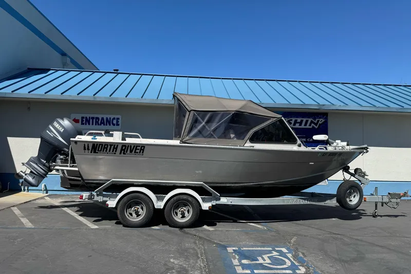 Slide: The Image of 2011 North River 21' Seahawk boat on trailer, parked outside a building. - 1