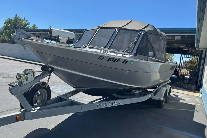 Slide: The Image of 2011 North River 21' Seahawk boat on trailer, parked outdoors under clear blue sky. - 10