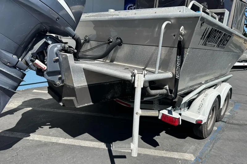 Slide: The Image of 2011 North River 21' Seahawk boat on trailer, featuring outboard motor and sturdy design. - 12