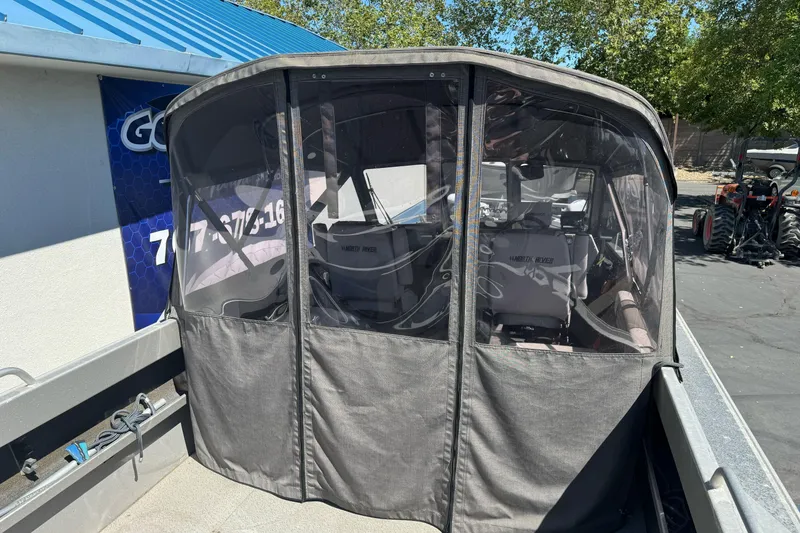 Slide: The Image of 2011 North River 21' Seahawk boat with covered seating area, parked outdoors. - 13