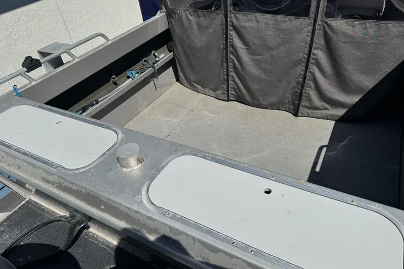 Slide: The Image of 2011 North River 21' Seahawk boat interior with storage compartments and seating area. - 14