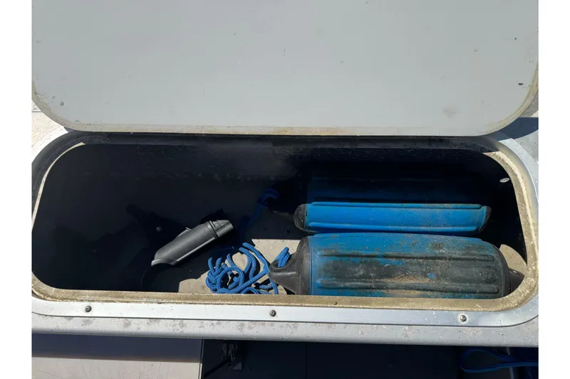 Slide: The Image of Open storage compartment on 2011 North River 21' Seahawk boat with blue fenders and rope. - 19