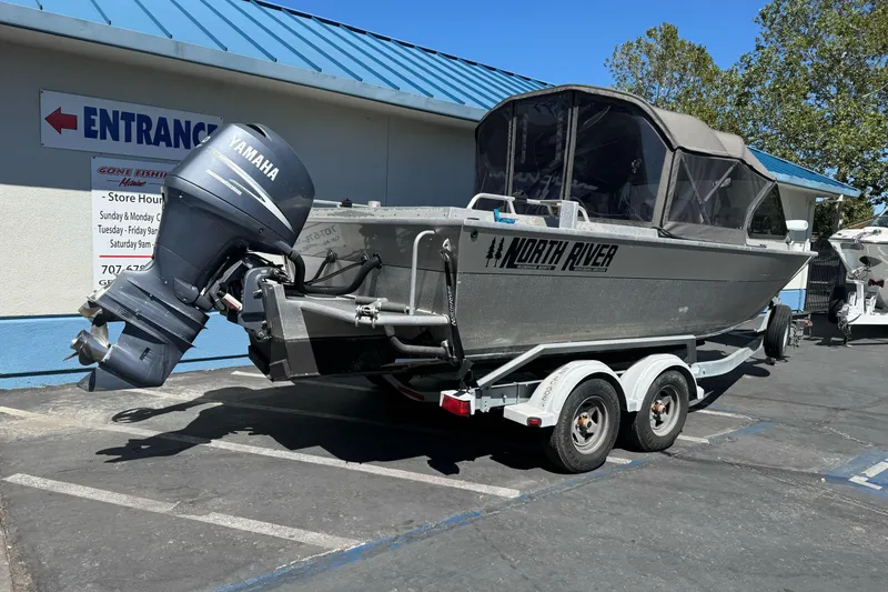 Slide: The Image of 2011 North River 21' Seahawk boat with Yamaha motor on trailer in parking lot. - 2