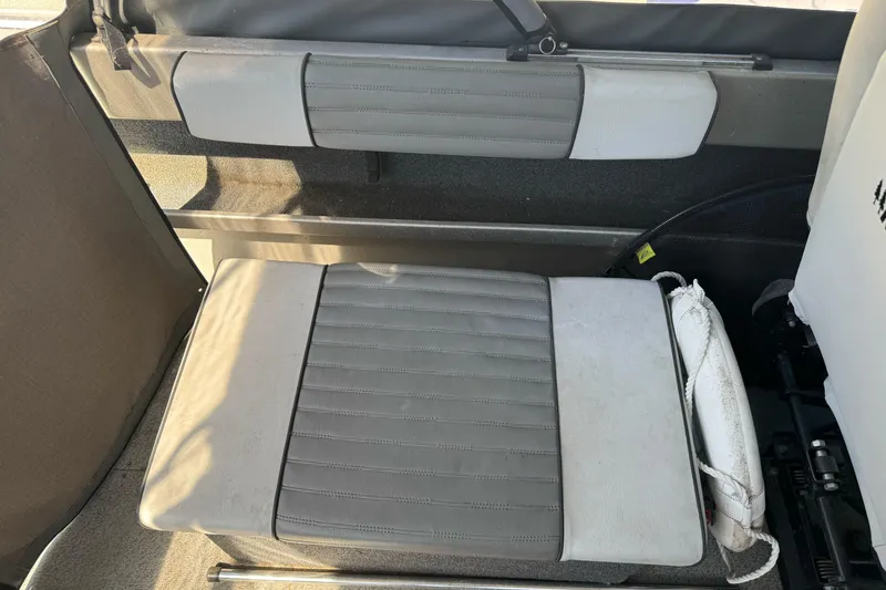 Slide: The Image of Interior seating of a 2011 North River 21' Seahawk boat, featuring gray upholstery. - 24