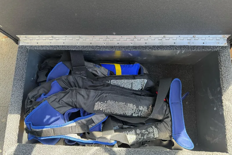 Slide: The Image of Storage compartment with life jackets on a 2011 North River 21' Seahawk boat. - 26