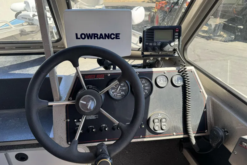 Slide: The Image of 2011 North River 21' Seahawk boat dashboard with steering wheel and Lowrance navigation system. - 27