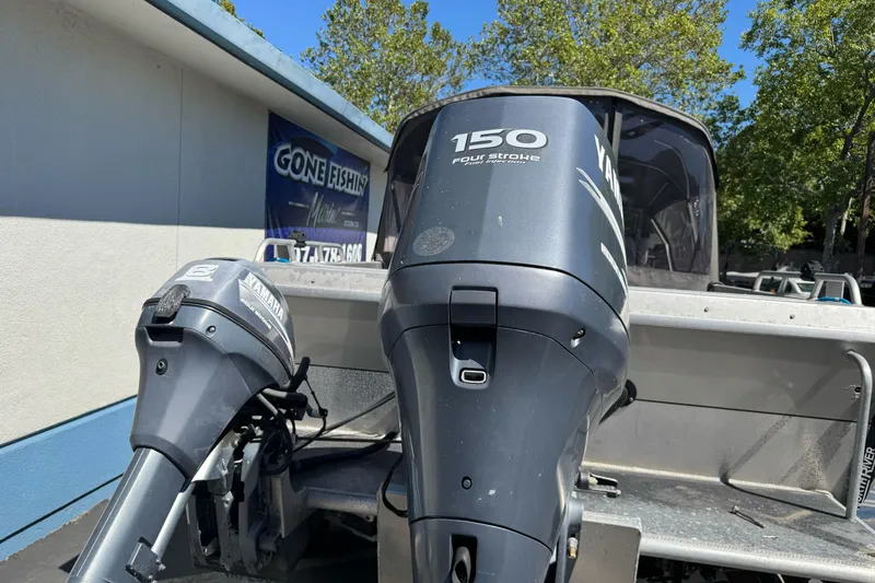Slide: The Image of 2011 North River 21' Seahawk boat with Yamaha outboard motors, parked outdoors. - 33