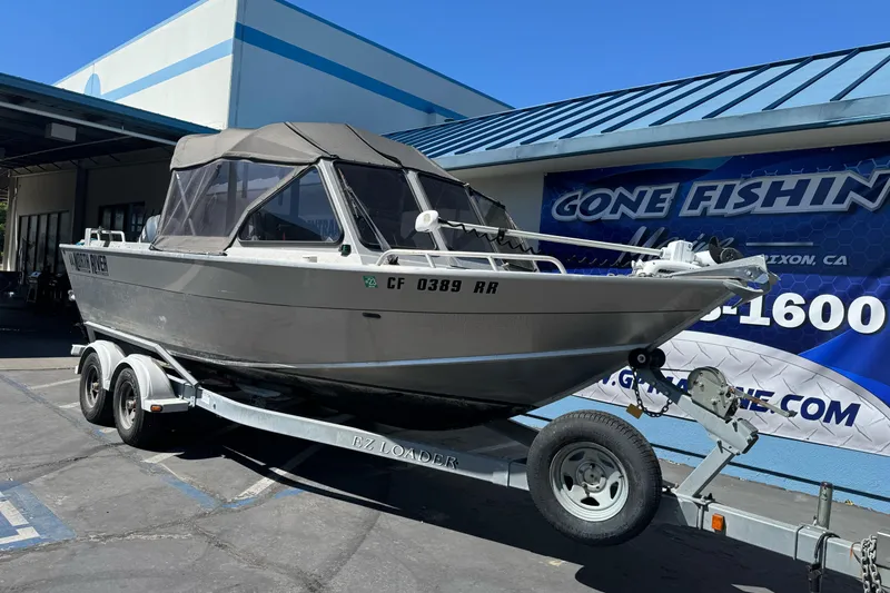 Slide: The Image of 2011 North River 21' Seahawk boat on trailer outside a fishing store. - 6