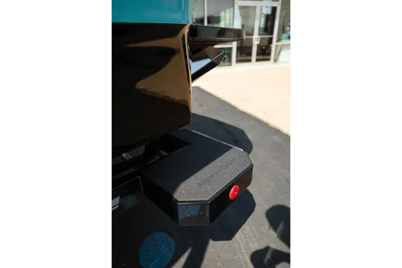 Slide: The Image of Rear view of 2026 MasterCraft XT24 boat with step platform and red light. - 18