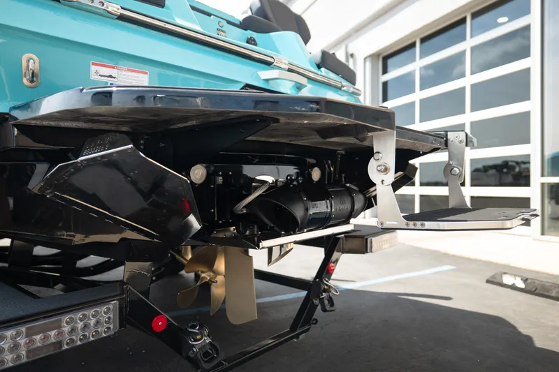 Slide: The Image of 2026 MasterCraft XT24 boat rear view, showcasing propeller and swim platform. - 7