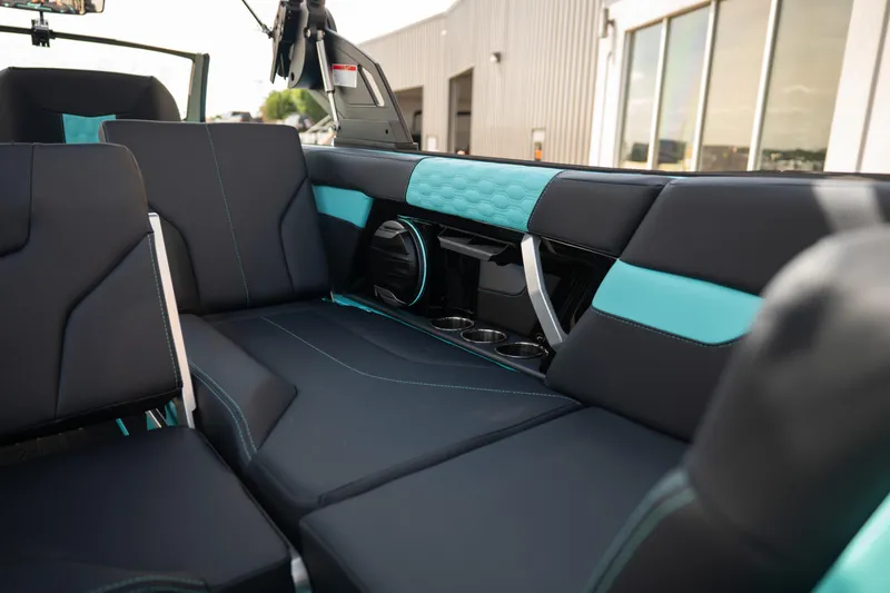 Slide: The Image of 2026 MasterCraft XT24 interior with sleek black and teal seating, cup holders, and modern design. - 30