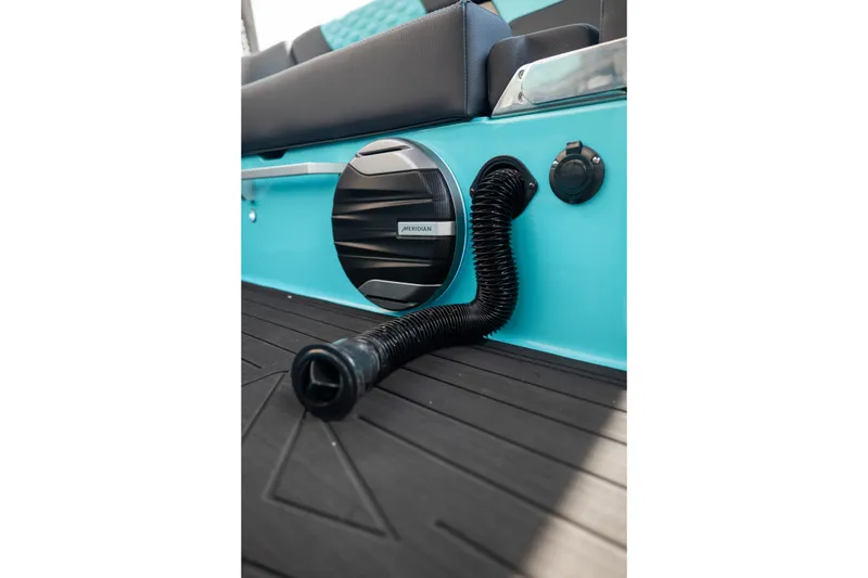 Slide: The Image of 2026 MasterCraft XT24 boat interior with Meridian speaker and flexible hose on turquoise panel. - 28