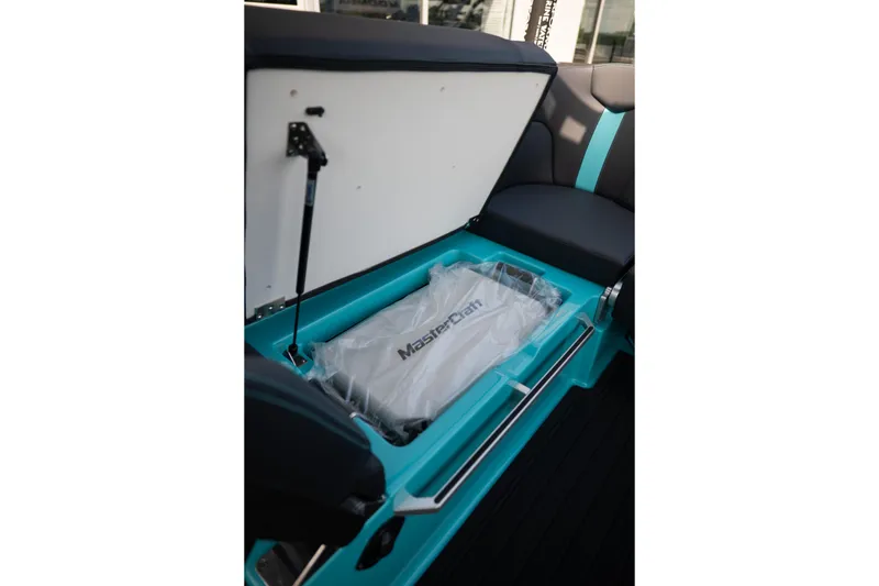 Slide: The Image of 2026 MasterCraft XT24 boat storage compartment with branded cover, showcasing sleek design and functionality. - 47