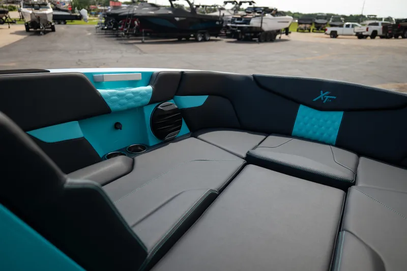 Slide: The Image of Interior of 2026 MasterCraft XT24 boat with sleek black and turquoise seating. - 43