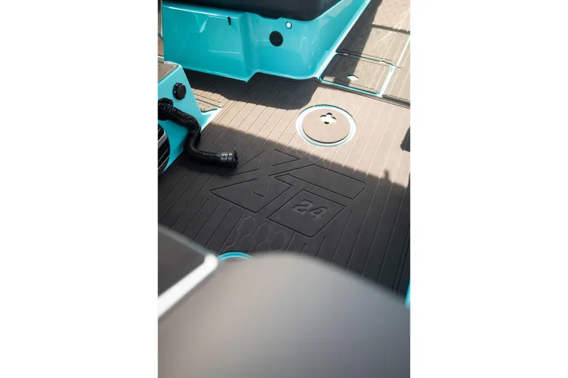 Slide: The Image of 2026 MasterCraft XT24 boat interior with embossed flooring and teal accents. - 34