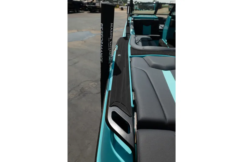 Slide: The Image of 2026 MasterCraft XT24 boat interior with sleek black and teal seating design. - 19