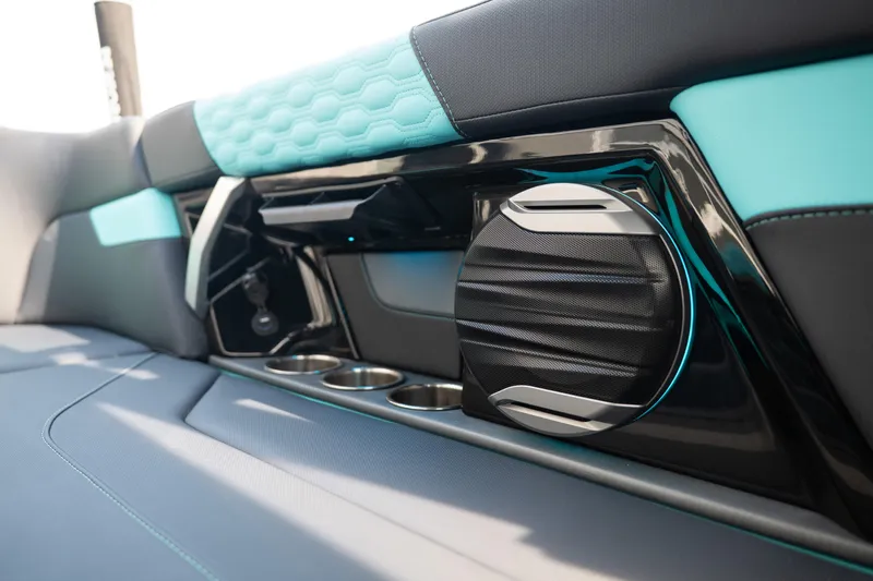 Slide: The Image of 2026 MasterCraft XT24 interior with sleek speaker design and cup holders. - 35