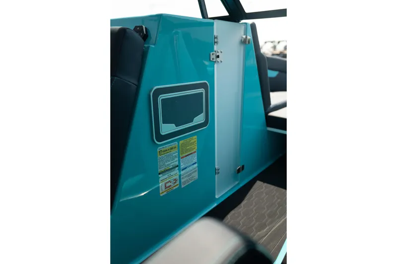 Slide: The Image of 2026 MasterCraft XT24 interior detail with teal panel and safety labels. - 26