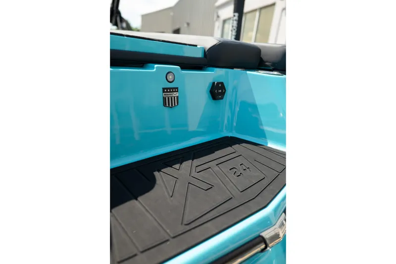 Slide: The Image of 2026 MasterCraft XT24 boat interior detail with logo and textured flooring. - 10