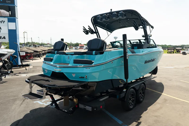 Slide: The Image of 2026 MasterCraft XT24 boat in a parking lot, showcasing sleek design and vibrant color. - 9