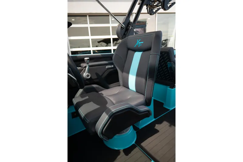 Slide: The Image of 2026 MasterCraft XT24 boat seat with sleek black and turquoise design. - 37