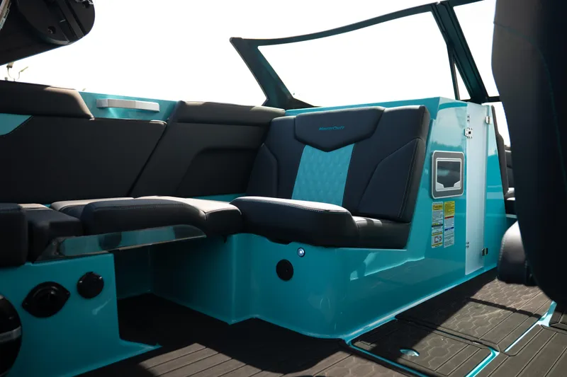 Slide: The Image of Interior of 2026 MasterCraft XT24 boat with sleek black and teal seating. - 27
