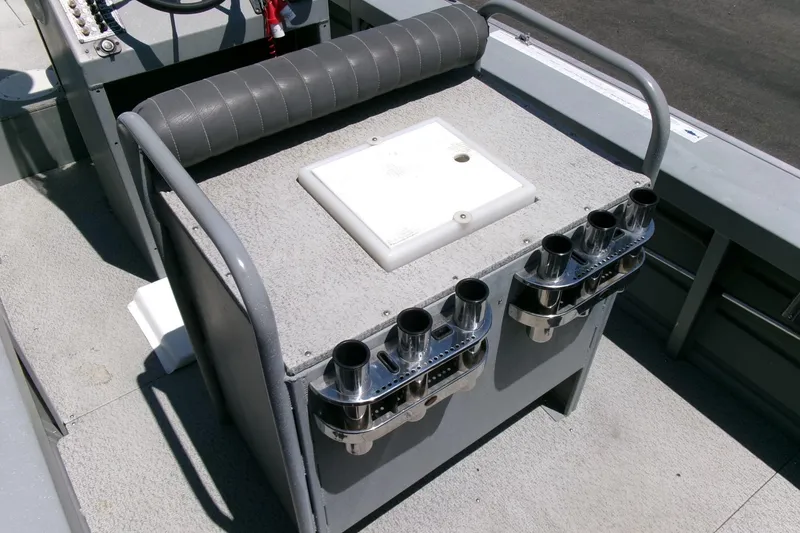Slide: The Image of 2010 Klamath 19 Bayrunner Baja boat interior with rod holders and cushioned seating. - 14