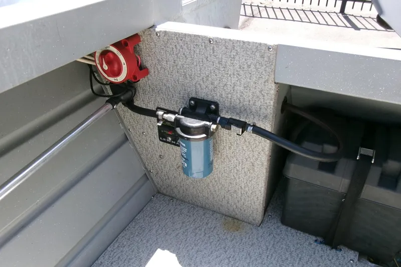 Slide: The Image of 2010 Klamath 19 Bayrunner Baja boat interior showing fuel filter and battery compartment. - 16