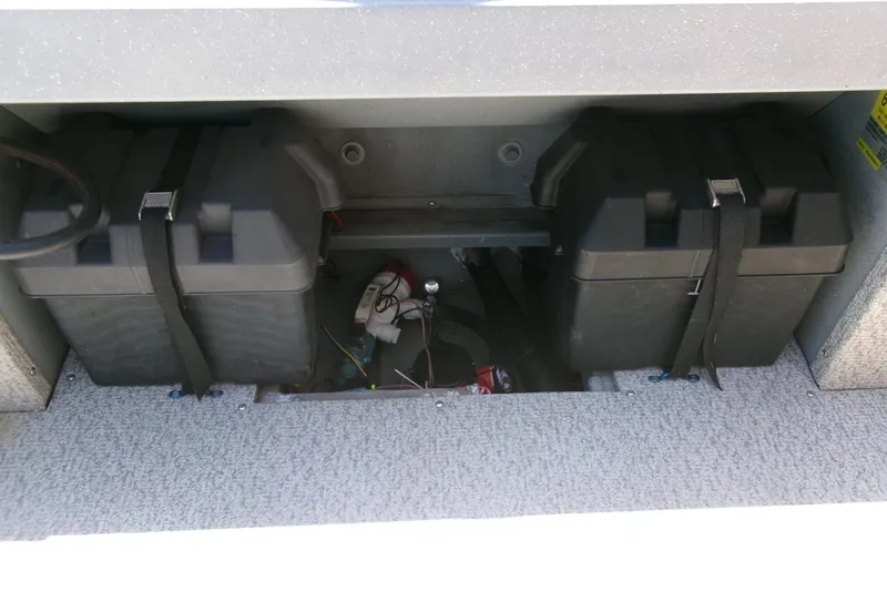 Slide: The Image of Battery compartment of 2010 Klamath 19 Bayrunner Baja boat, featuring secured battery boxes. - 17
