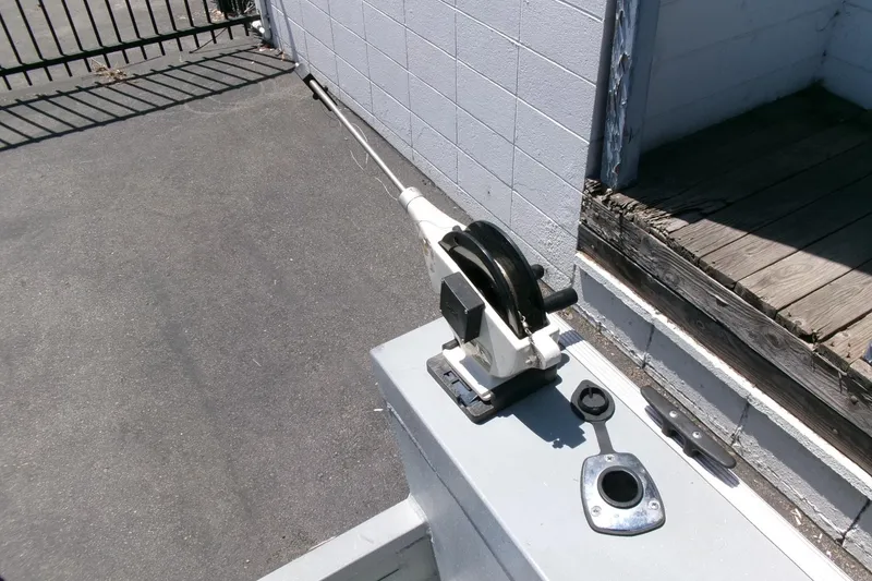 Slide: The Image of Boat control lever on a 2010 Klamath 19 Bayrunner Baja, docked near a wooden platform. - 18