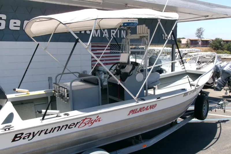 Slide: The Image of 2010 Klamath 19 Bayrunner Baja boat on trailer, featuring canopy and fishing equipment. - 19
