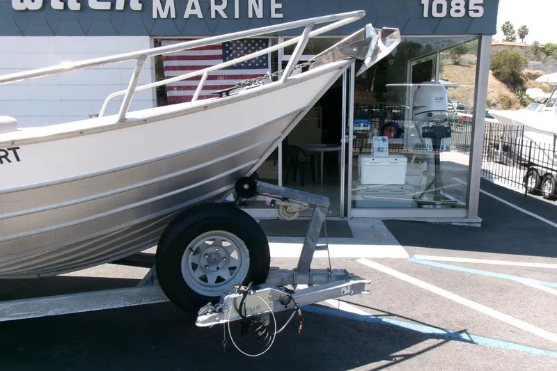 Slide: The Image of 2010 Klamath 19 Bayrunner Baja boat on trailer outside marine shop. - 20