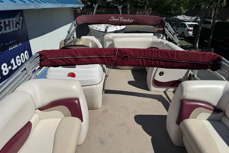 Slide: The Image of 2011 Sun Tracker Party Barge 21 interior with maroon and cream seating. - 14