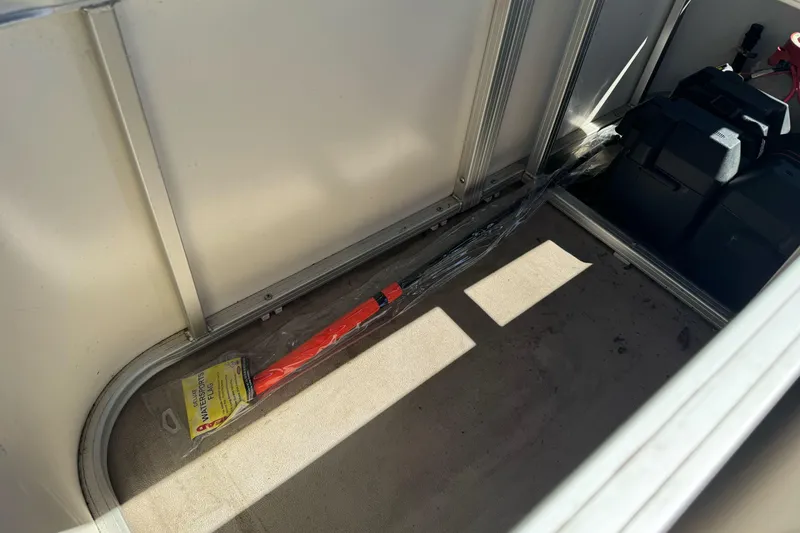 Slide: The Image of Interior of a 2011 Sun Tracker Party Barge 21 with storage compartment and equipment. - 17