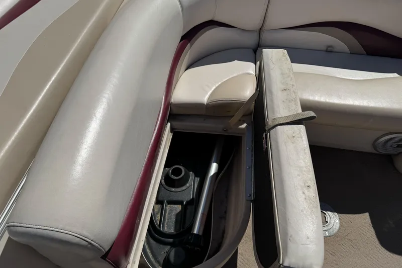Slide: The Image of 2011 Sun Tracker Party Barge 21 interior storage compartment with beige and maroon seating. - 18