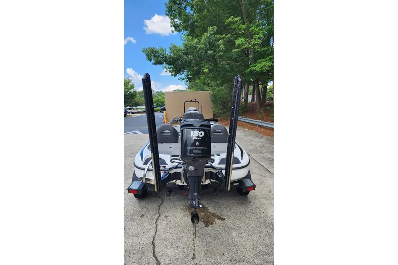 Slide: The Image of 2017 Nitro Z18 boat with 150 horsepower engine, parked outdoors near trees. - 6