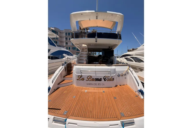 Slide: The Image of 2007 Viking Princess 54 Flybridge yacht docked, featuring spacious teak deck and elegant design. - 10