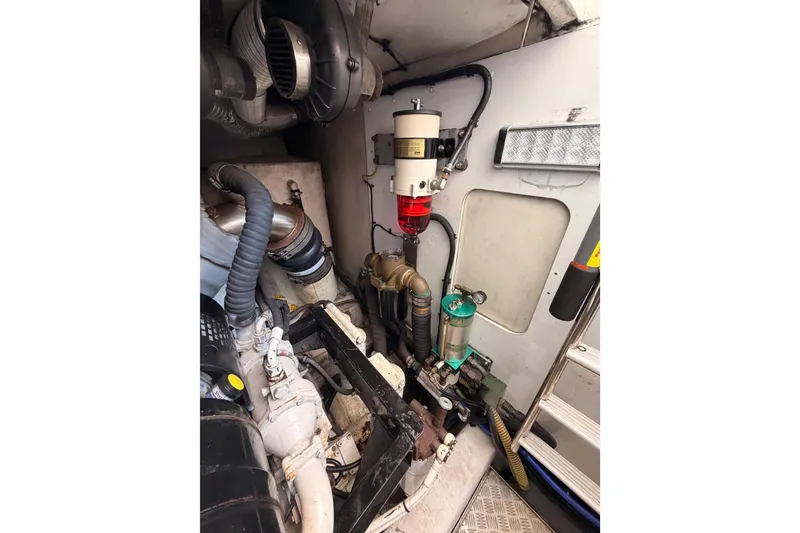 Slide: The Image of Engine room of 2007 Viking Princess 54 Flybridge yacht, showcasing mechanical components and systems. - 100