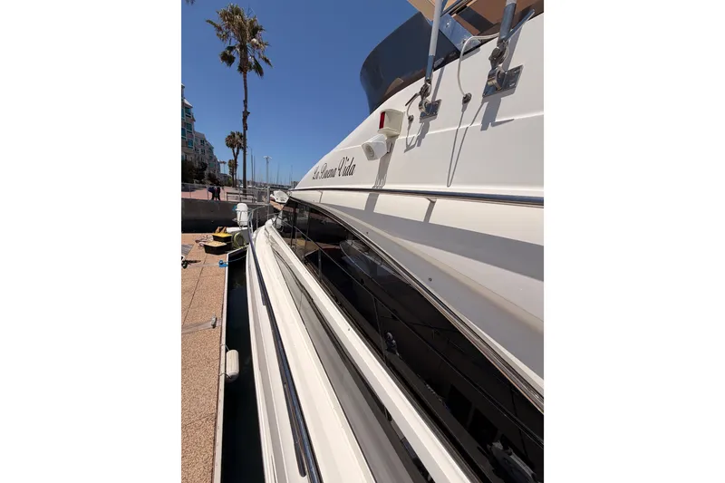 Slide: The Image of 2007 Viking Princess 54 Flybridge yacht docked under clear blue sky. - 15