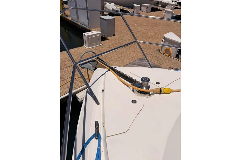 Slide: The Image of Bow of 2007 Viking Princess 54 Flybridge yacht docked with power cable connected. - 18