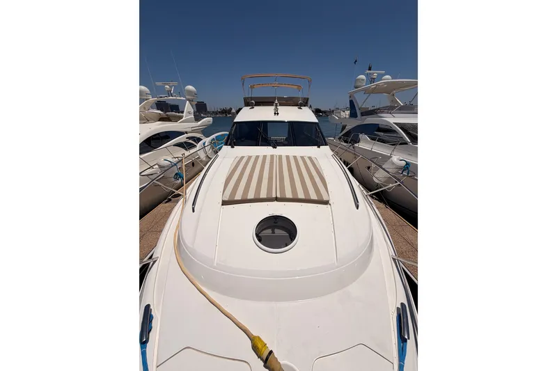 Slide: The Image of 2007 Viking Princess 54 Flybridge yacht docked, showcasing sleek design and spacious deck. - 19