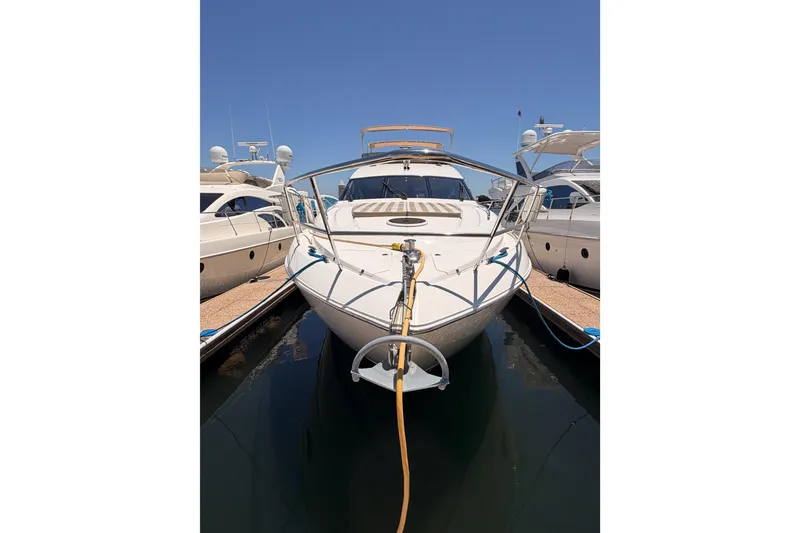 Slide: The Image of 2007 Viking Princess 54 Flybridge yacht docked at marina under clear blue sky. - 2