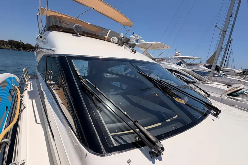 Slide: The Image of 2007 Viking Princess 54 Flybridge yacht docked at marina under clear blue sky. - 20