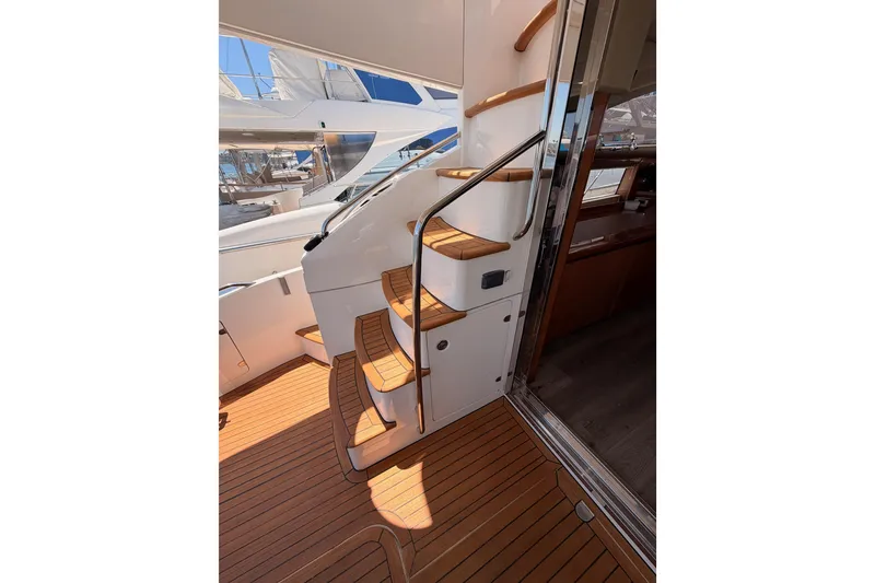 Slide: The Image of Staircase on 2007 Viking Princess 54 Flybridge yacht with teak flooring and sleek design. - 23