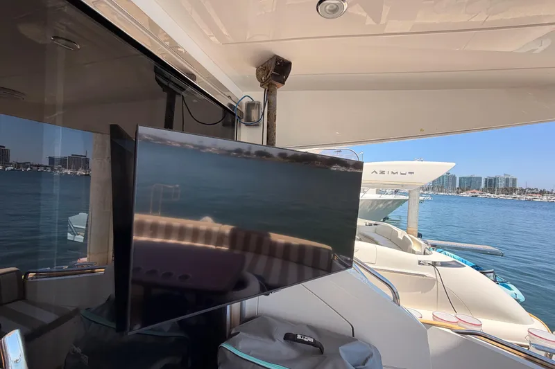 Slide: The Image of Flybridge of 2007 Viking Princess 54 with TV, marina view, and neighboring yacht. - 24