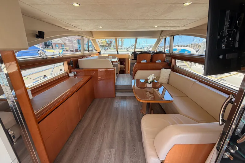 Slide: The Image of Luxurious interior of 2007 Viking Princess 54 Flybridge yacht with elegant seating and wood finishes. - 25